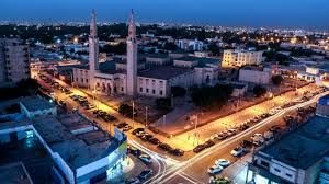 Nouakchott city centre and mosque minarets lit up at dusk